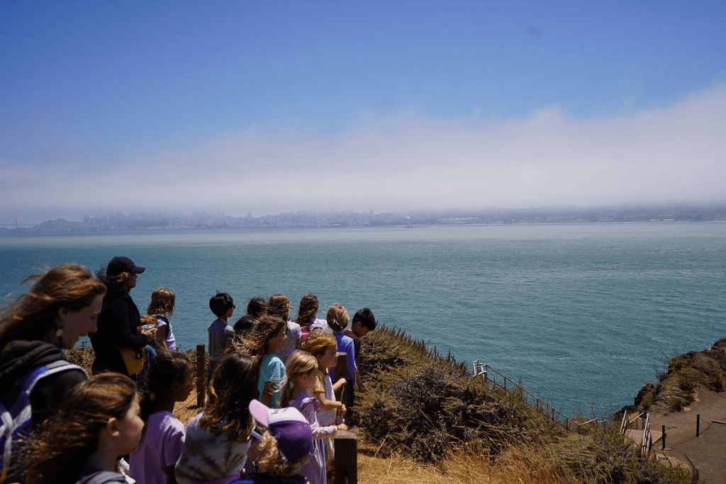 A group of children overlooking the water after a walk through Battery Yates