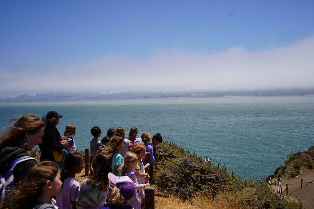 A group of children overlooking the water after a walk through Battery Yates