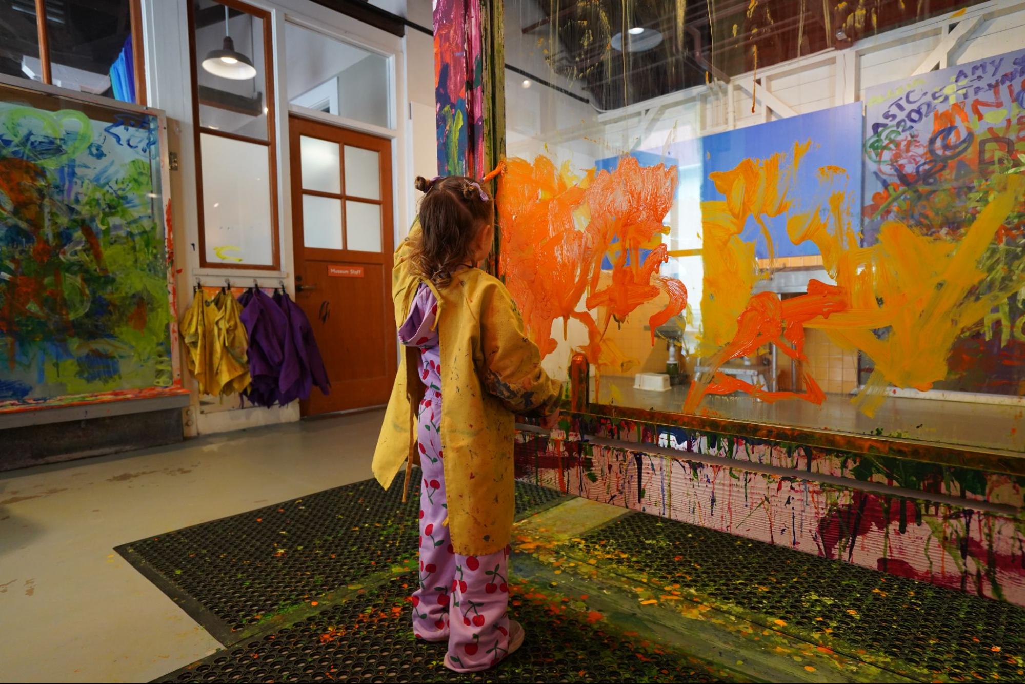 A young girl creates art at the Painter’s Place of the Bay Area Discovery Museum