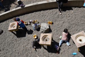 Young kids playing in a gravel pit at a children’s interactive museum
